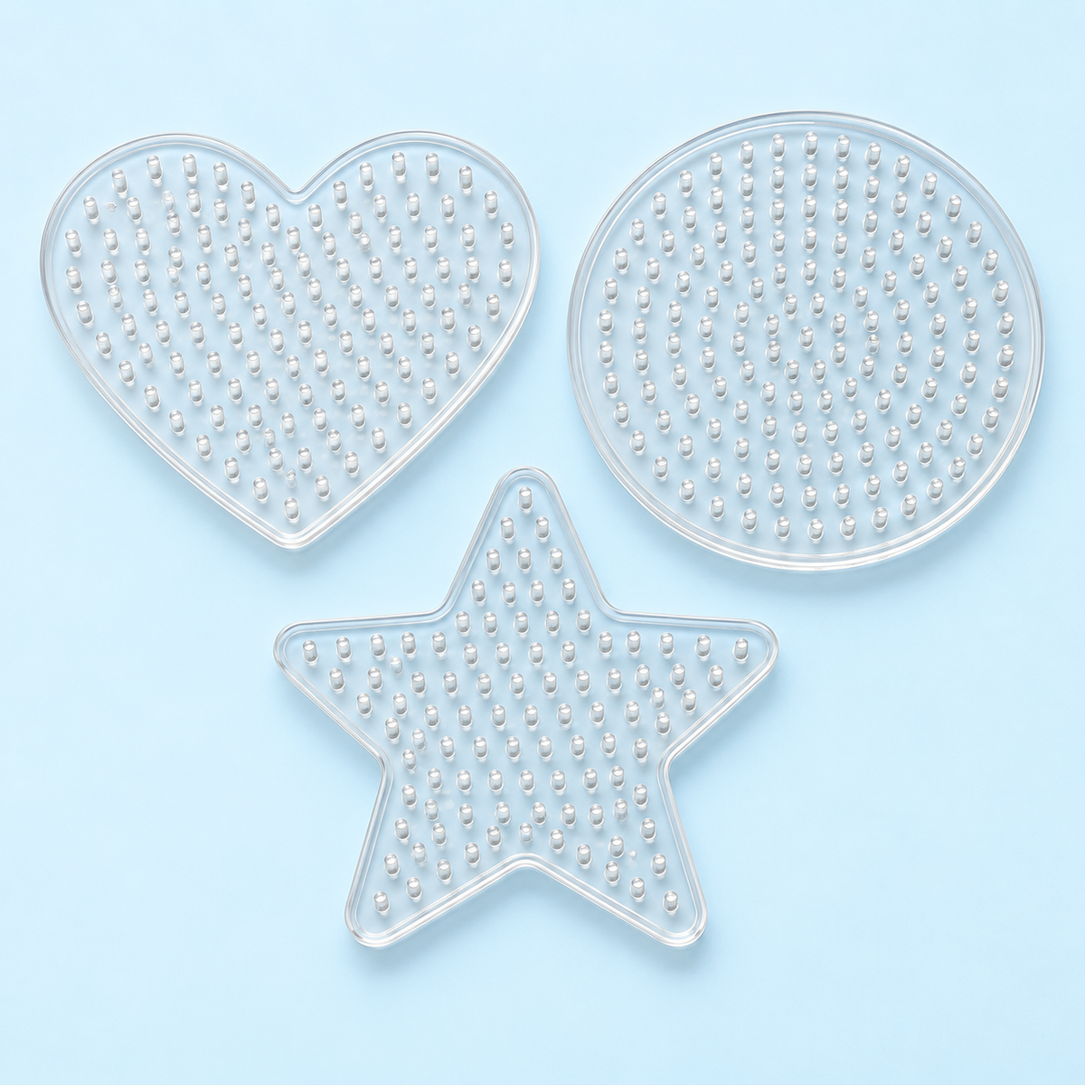 Concept image of clear heart, star and round fuse bead pegboards