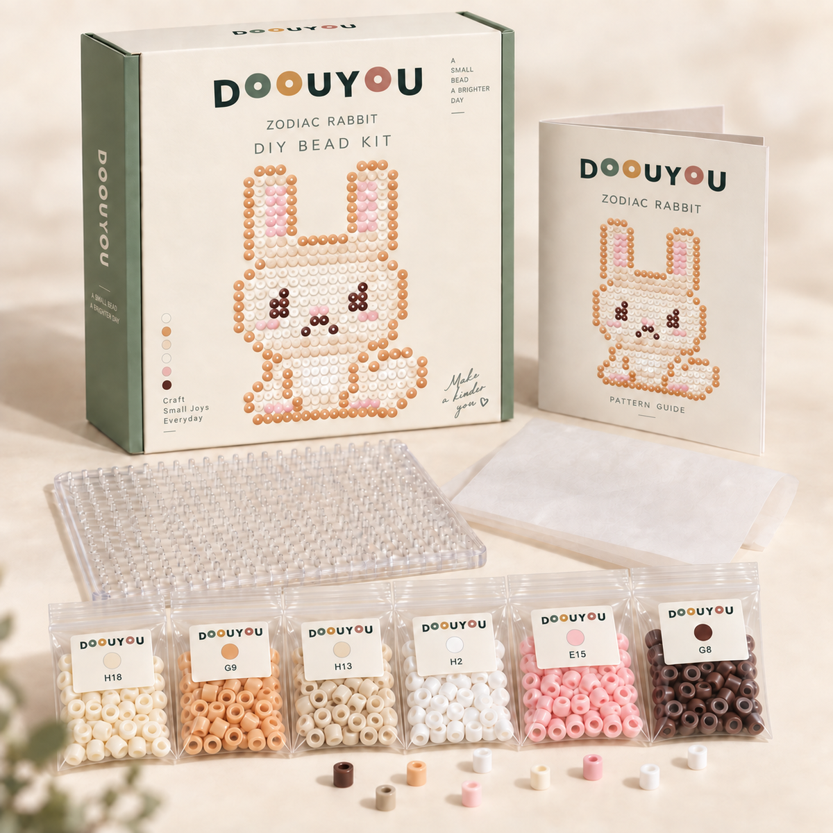DOOUYOU Zodiac Rabbit DIY kit concept: packaging, color-sorted bead bags, pegboard, ironing paper and chart; digital illustration, not a product photo.