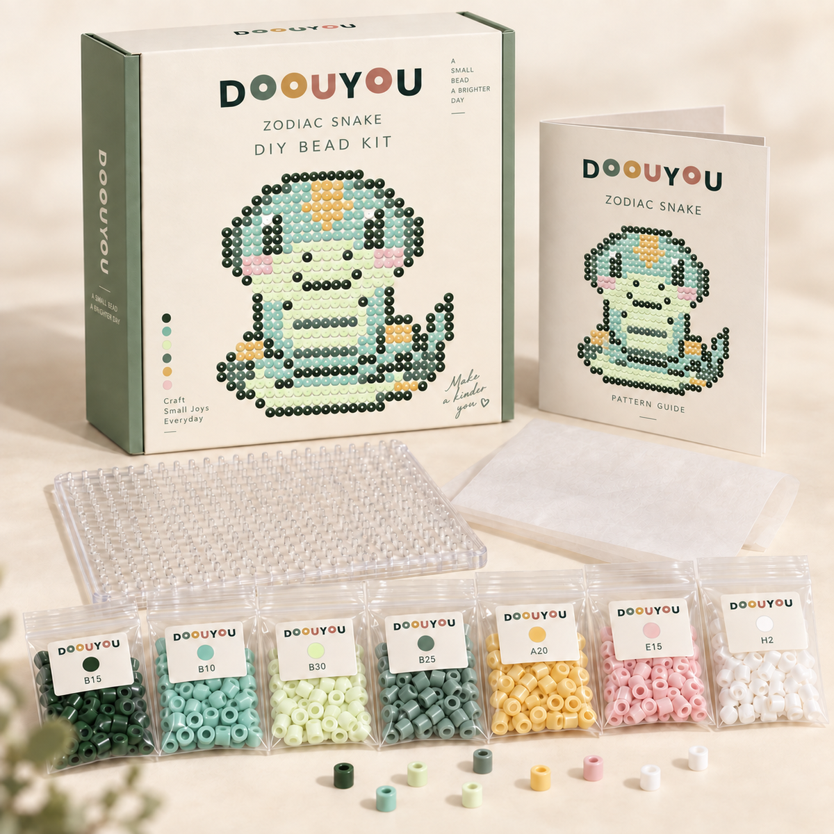 DOOUYOU Zodiac Snake DIY kit concept: packaging, color-sorted beads, pegboard, tweezers, ironing paper and chart; digital illustration, not a product photo.